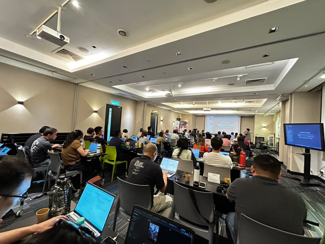 AI literacy training in Malaysia — a full room of professionals learning to use AI at an AITraining2U class